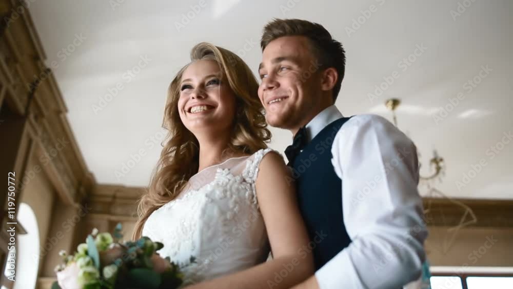 Bride and groom laugh near the window Bride and groom laugh near the window