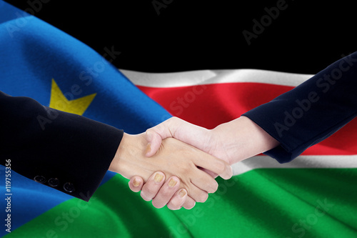 Negotiation handshake with flag of South Sudan