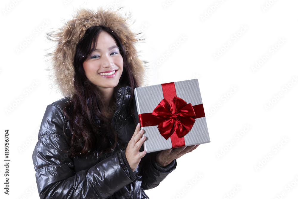 Woman wearing jacket holds a gift Woman wearing jacket holds a gift