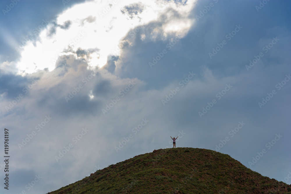 The woman on the top of a high mountain.
