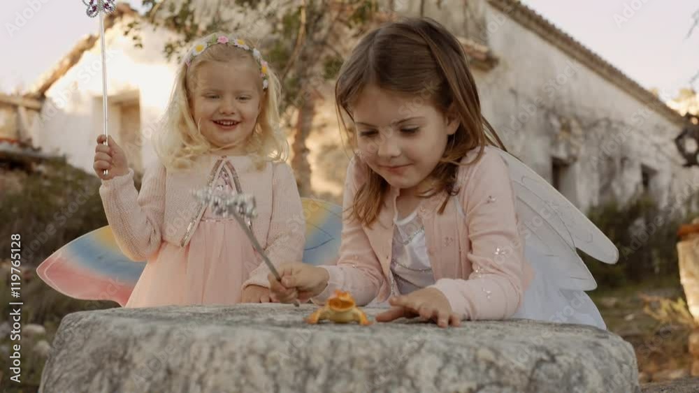 Two children playing with magic wands Two children playing with magic wands