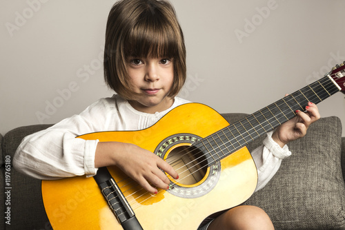 Little girl playing guitar