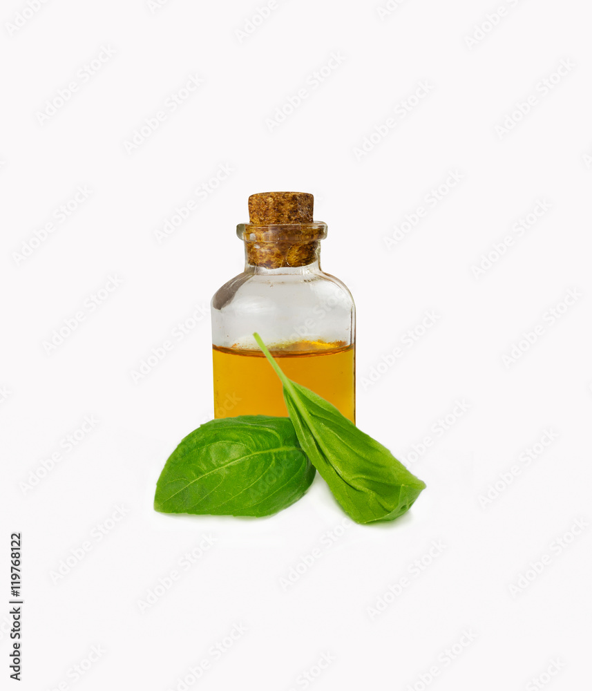 Basil essential oils in bottle isolated on white Basil essential oils in bottle isolated on white