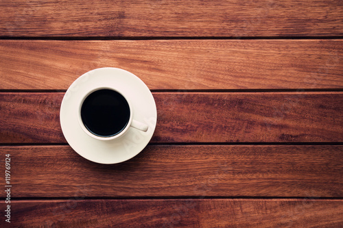 Black coffee on brown wooden table background