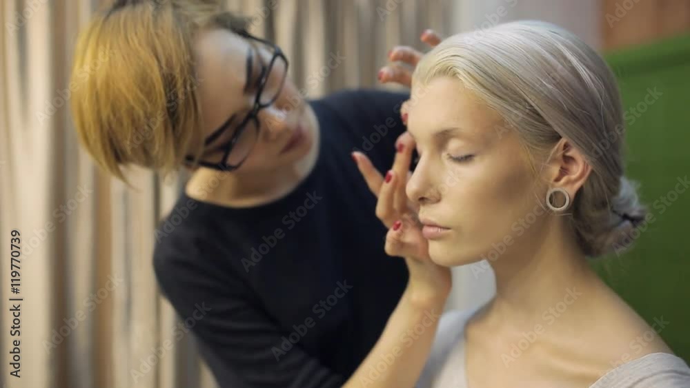 Close up view of female model making up. Close up view of female model making up.