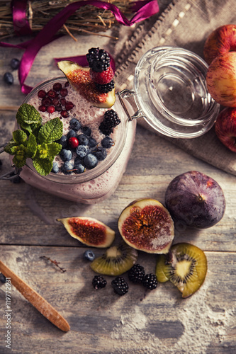 Fototapeta Naklejka Na Ścianę i Meble -  bright detox smoothie with berries on wooden background bowl