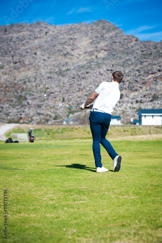 golfer playing a chip shot onto the green