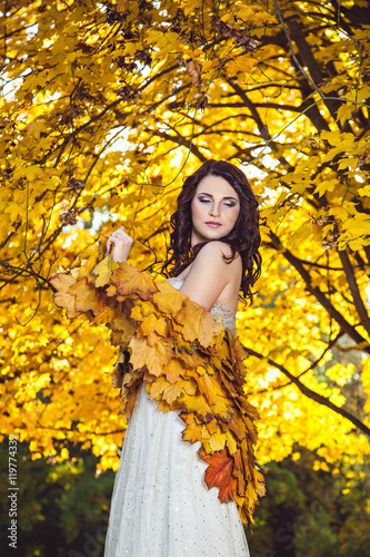 Elegant Woman Standing In A Park In Autumn