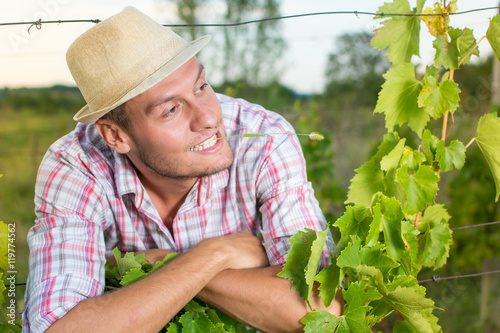 Happy young farmer at the vineyard