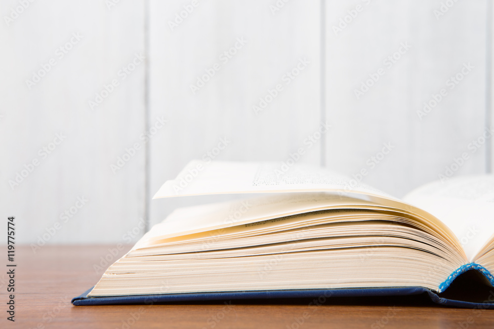 Open book on the desk over wooden background Open book on the desk over wooden background