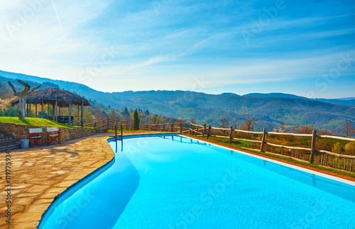 Outdoor swimming pool in the countryside with views of the hills