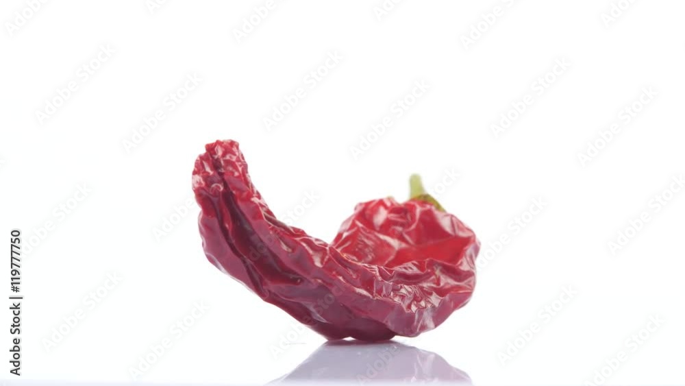 Dried red hot chili peppers on white background. Rotating. Close up Dried red hot chili peppers on white background. Rotating. Close up