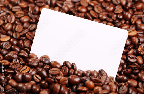 Against the backdrop of coffee beans is a business card