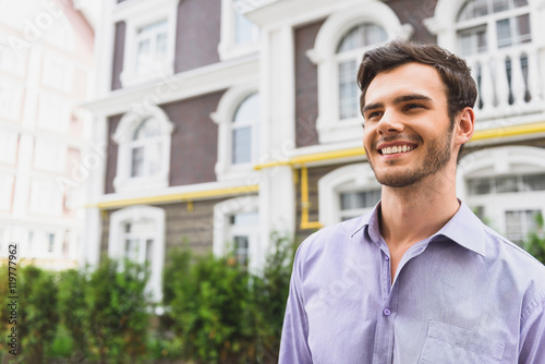 Cheerful guy viewing urban architecture