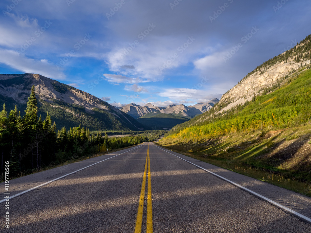Beautiful landscape of a road through Rocky Mountains during the early hours of the morning.