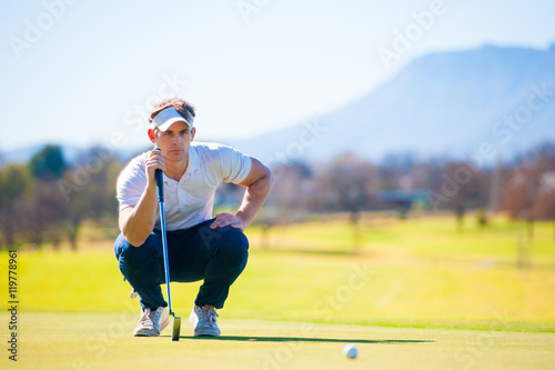 view of a golfer planning his shot to the pin