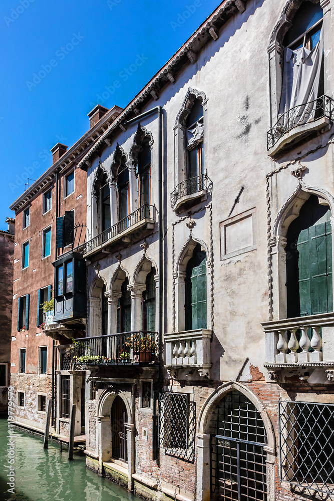 Fototapeta premium Canal with beautiful medieval facades. Venice, Italy.