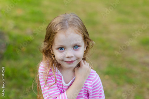 Portrait of a cute girl with long blond hair