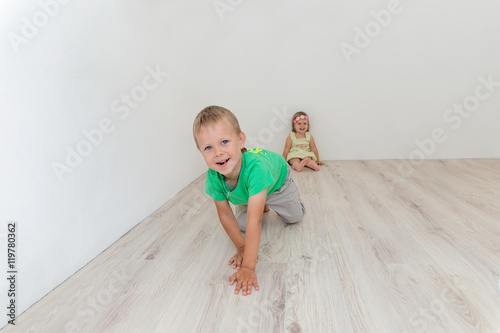 Beautiful boy and girl sitting on the floor