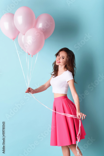 Pretty girl holding pink balloons