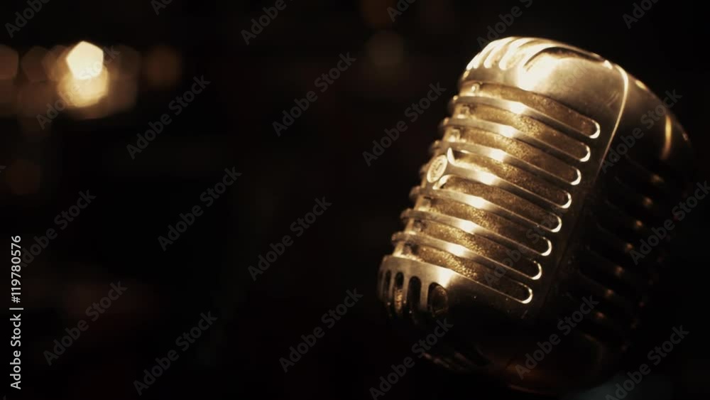 Concert metal microphone stand on stage in empty retro club. Spotlights. Glare. Close up.