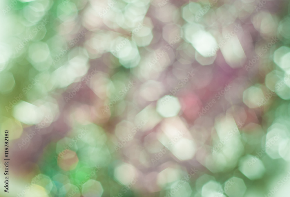 Fototapeta premium Blurred background with bokeh lights in shades of green and pink