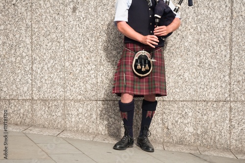 Quadro em tela bagpiper dressed in kilt playing bag pipes