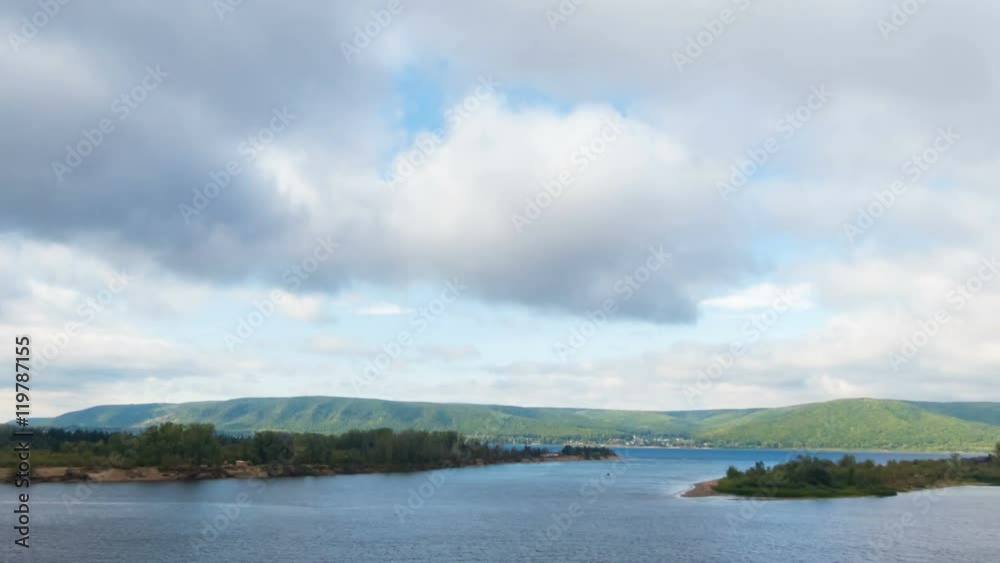 Top view of the river, islands and mountains on the horizon. The movement of clouds across the sky. Time Lapse. Top view of the river, islands and mountains on the horizon. The movement of clouds across the sky. Time Lapse.
