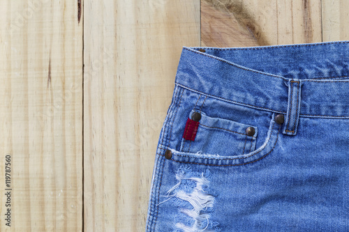 Blue jean skirt design on wood background