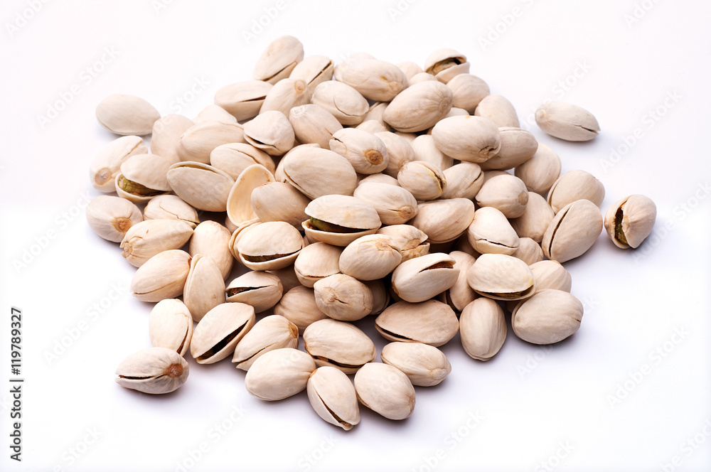 Roasted and salted pistachios in shell on white background Roasted and salted pistachios in shell on white background
