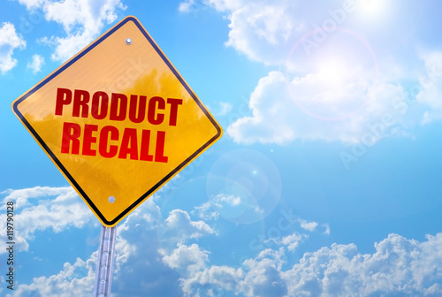 product recall word on yellow traffic sign blue sky background