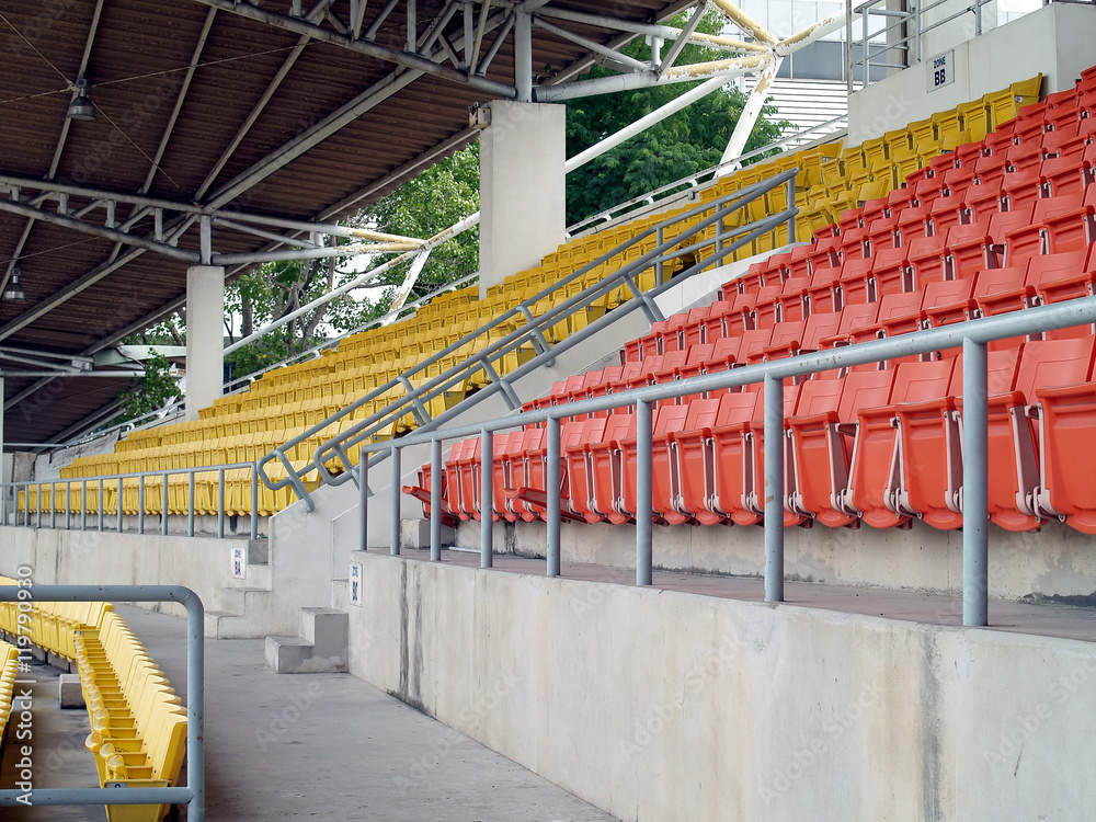 Fototapeta premium row of colourful stadium grandstand seats in sport arena without sport competition