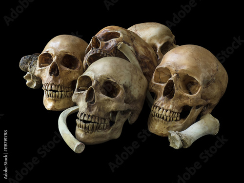 Pile of skulls and bones, isolated on black background with clipping path