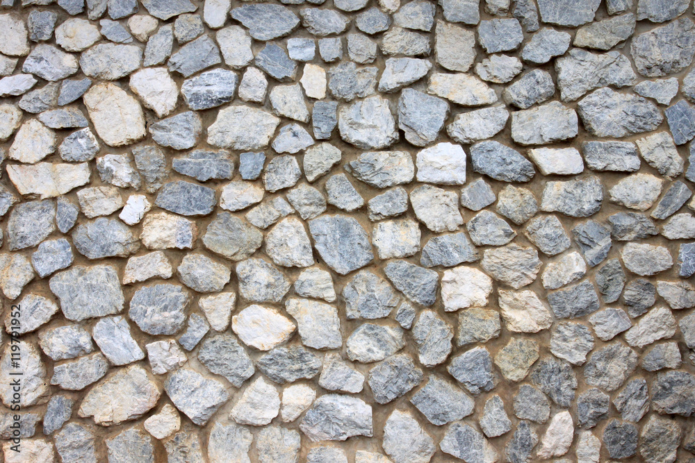 old stone wall Texture in weathered and have natural surfaces. old stone wall Texture in weathered and have natural surfaces.