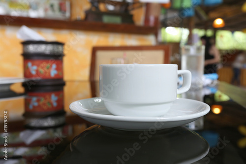 White coffee cup placed on the foods table.