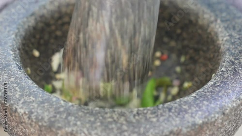 Close Up Shot Of Chilli And Garlic Pounding In Stone Mortar Footage