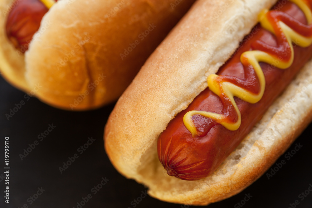 Barbecue Grilled Hot Dog with Yellow Mustard and ketchup on wooden table. Fast food. Barbecue Grilled Hot Dog with Yellow Mustard and ketchup on wooden table. Fast food.