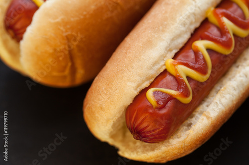 Barbecue Grilled Hot Dog with Yellow Mustard and ketchup on wooden table. Fast food.