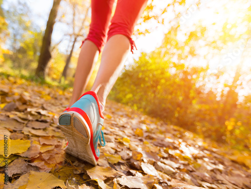 Close up of feet of a runner running in leaves