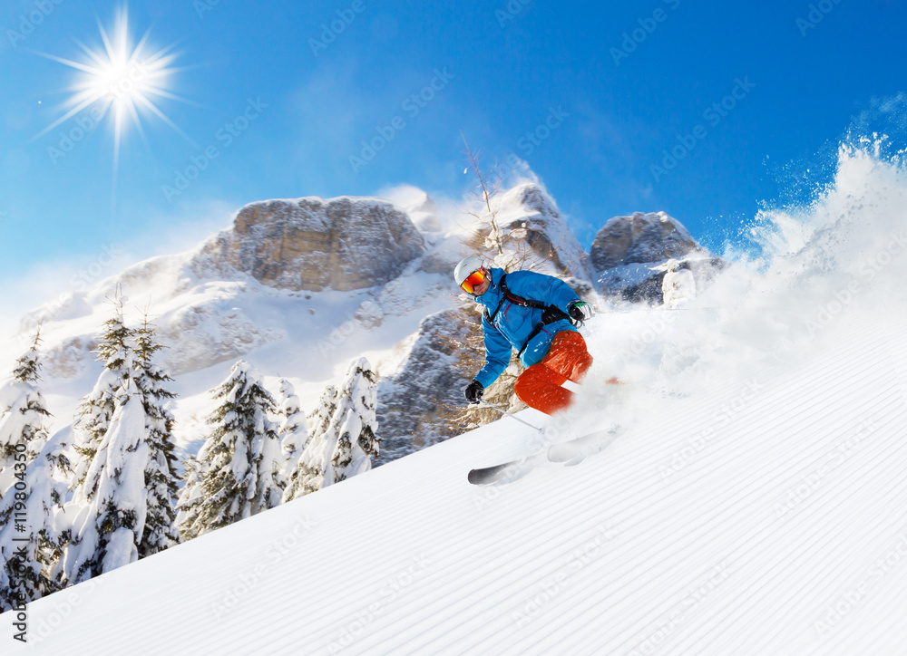 Skier on piste running downhill