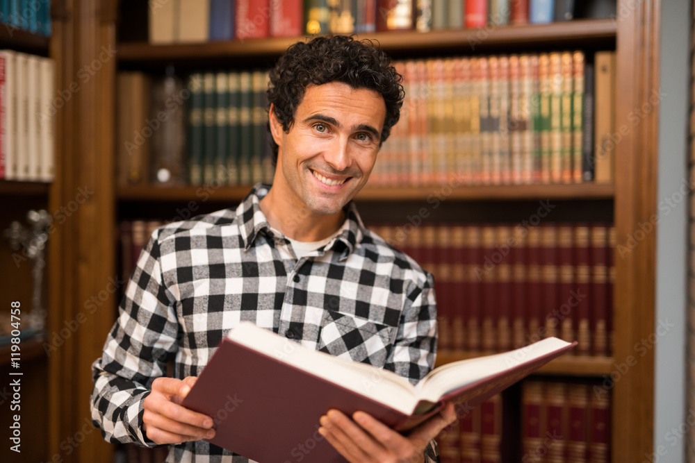 Smiling man reading a book Smiling man reading a book