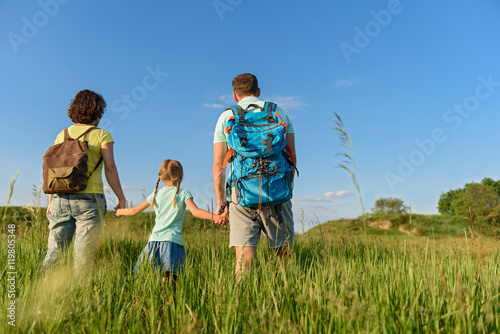 Young family hiking on mountain