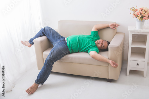 lazy Fat obese man sleeping on the couch