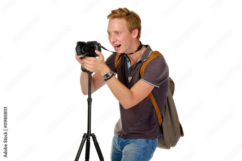 Young man traveler taking pictures by dslr camera on tripod isolated on white