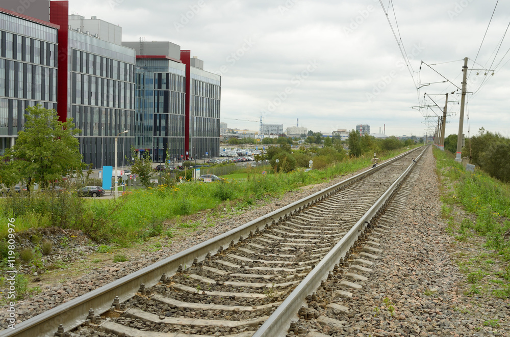 Fototapeta premium The railroad through the town.