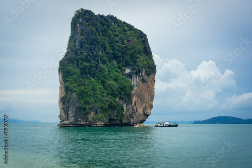 Cliff on small island and tourist boats in Krabi, Thailand