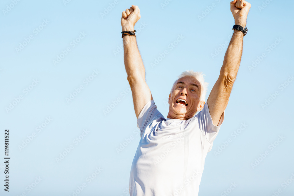 Handsome man in sport wear with outstretched arms Handsome man in sport wear with outstretched arms