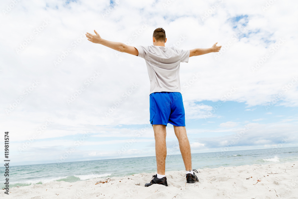Young man in sport wear with outstretched arms Young man in sport wear with outstretched arms