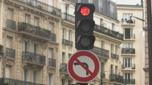 Traffic light in the street. Sign of left turn prohibited. Find way for detour. Stop at red light.