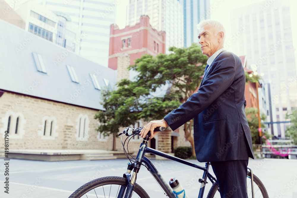 Fototapeta premium Successful businessman riding bicycle